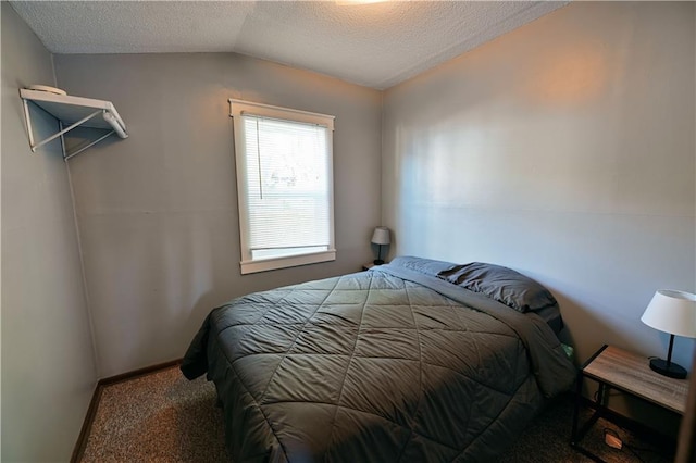 bedroom featuring baseboards, vaulted ceiling, carpet flooring, and a textured ceiling