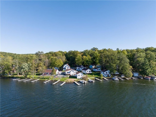 drone / aerial view featuring a water view and a residential view