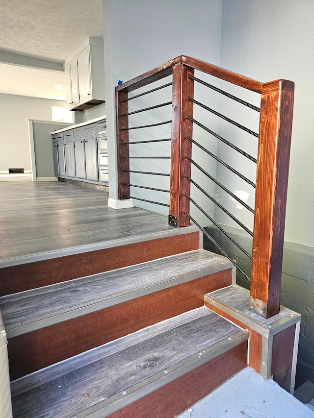 stairs with hardwood / wood-style floors