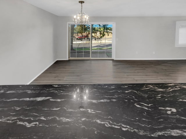 unfurnished dining area featuring dark hardwood / wood-style flooring and a notable chandelier