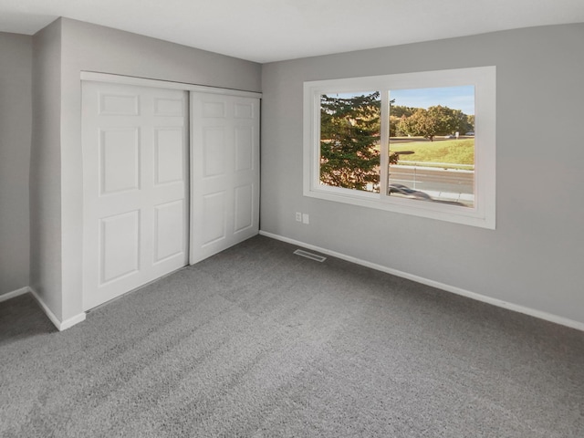 unfurnished bedroom featuring a closet and carpet flooring