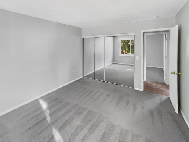 unfurnished bedroom featuring carpet floors and a closet