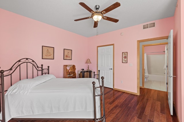 bedroom featuring a textured ceiling, dark hardwood / wood-style floors, ceiling fan, and ensuite bathroom