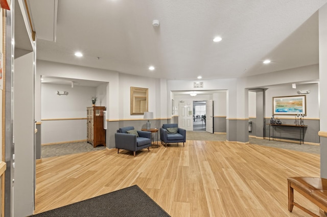 living room featuring a textured ceiling and light hardwood / wood-style floors