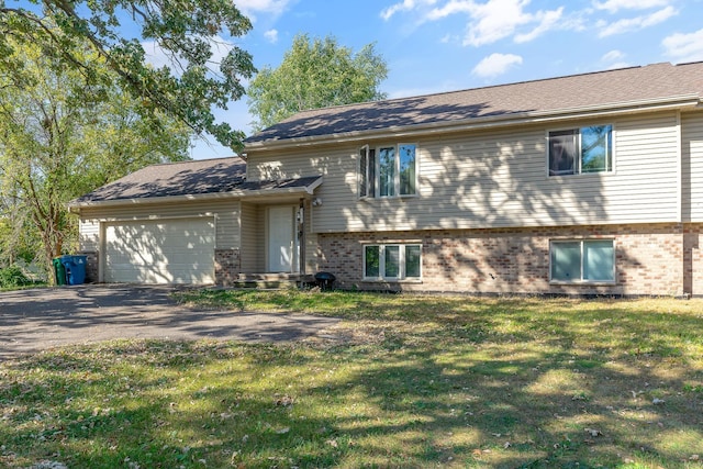 view of front of home with a garage and a front lawn