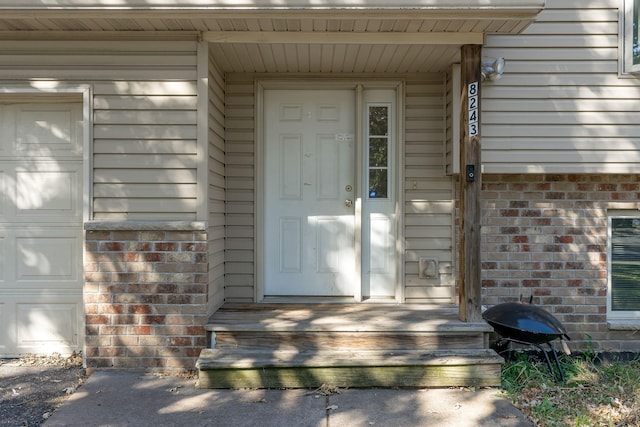 view of exterior entry with a garage