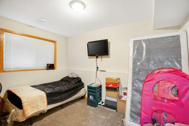 carpeted bedroom featuring a textured ceiling