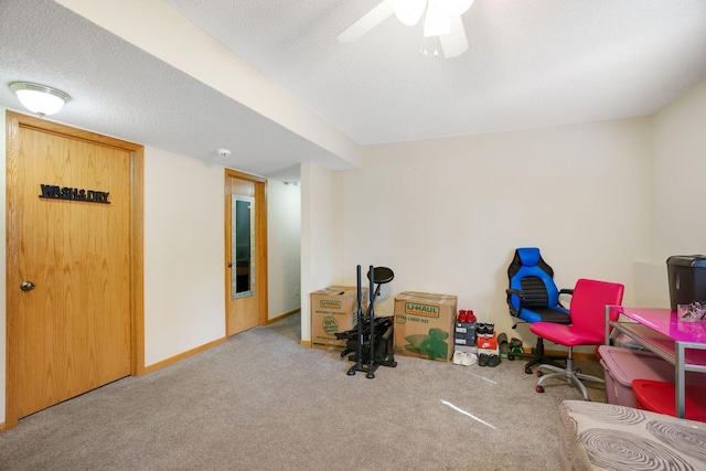 miscellaneous room featuring a textured ceiling, ceiling fan, and light carpet