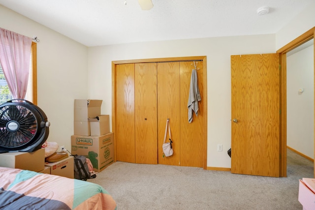 bedroom with light carpet, a closet, and ceiling fan