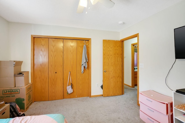 carpeted bedroom with a closet and ceiling fan