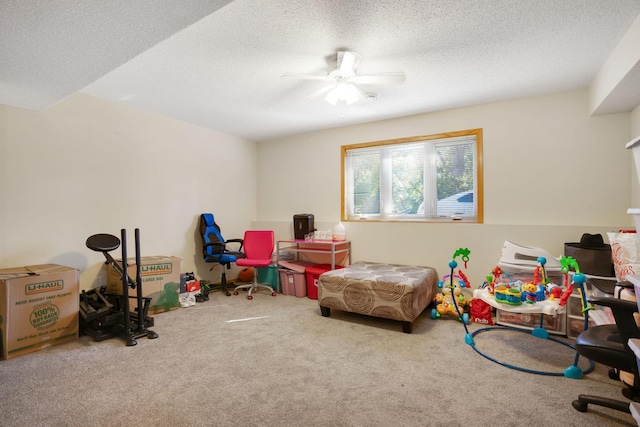 rec room featuring carpet floors, a textured ceiling, and ceiling fan