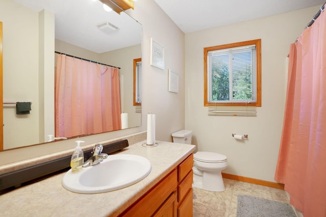 bathroom with vanity, toilet, and tile patterned floors