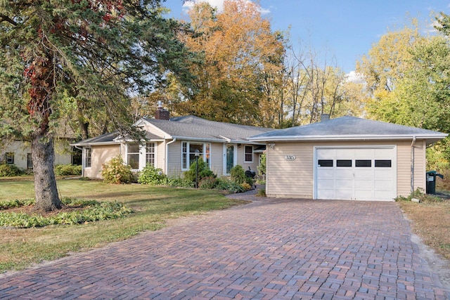 ranch-style home featuring a front yard and a garage