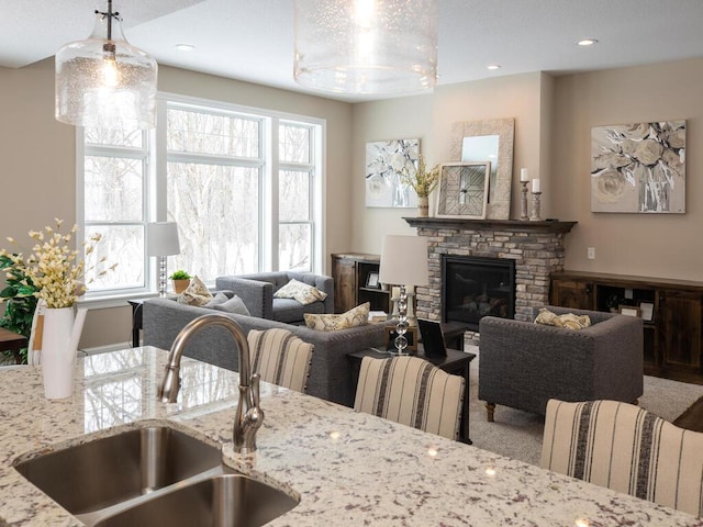 interior space featuring carpet floors, a fireplace, and sink