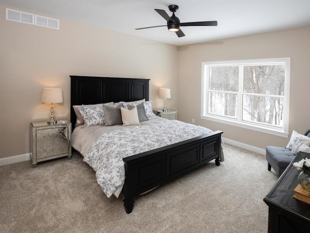 bedroom with ceiling fan, baseboards, light colored carpet, and visible vents