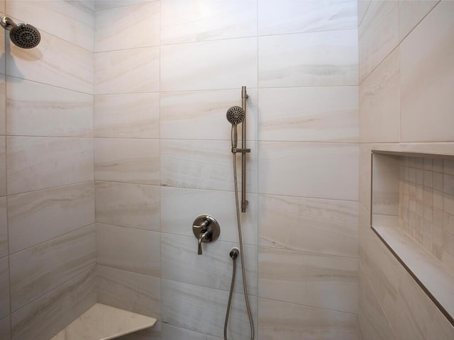 bathroom with tiled shower