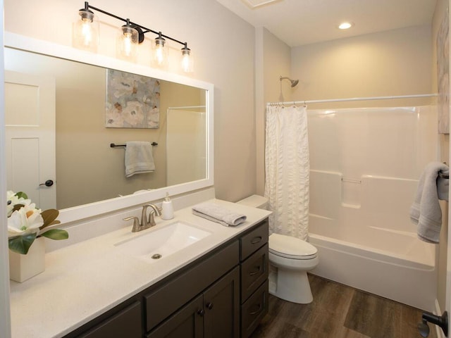 bathroom with wood finished floors, toilet, recessed lighting, vanity, and shower / tub combo with curtain