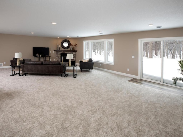 living room with baseboards, carpet floors, recessed lighting, and a brick fireplace