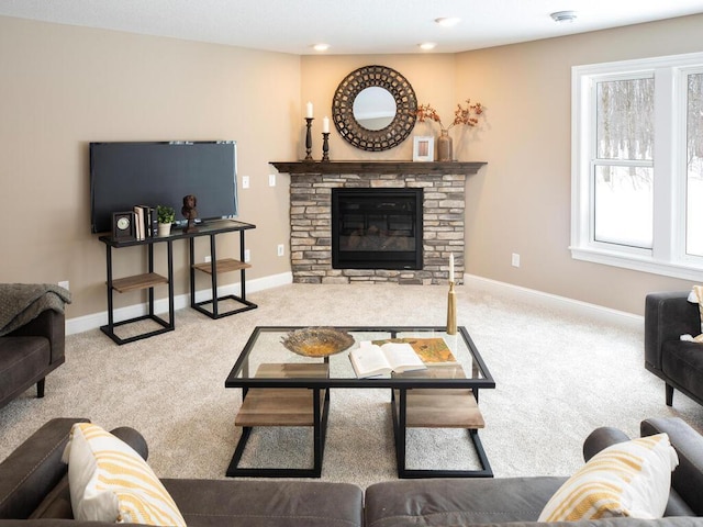 carpeted living room featuring a stone fireplace