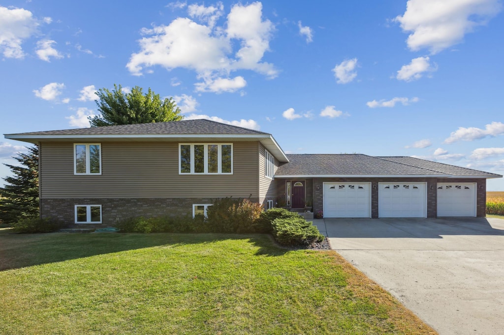 view of front of property featuring a garage and a front lawn