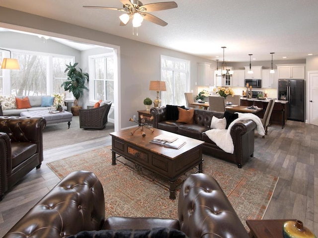 living area with a ceiling fan, recessed lighting, and wood finished floors