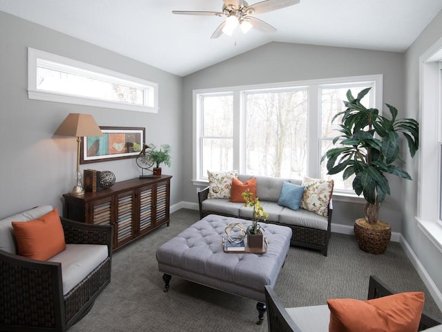 carpeted living area featuring baseboards, vaulted ceiling, and ceiling fan