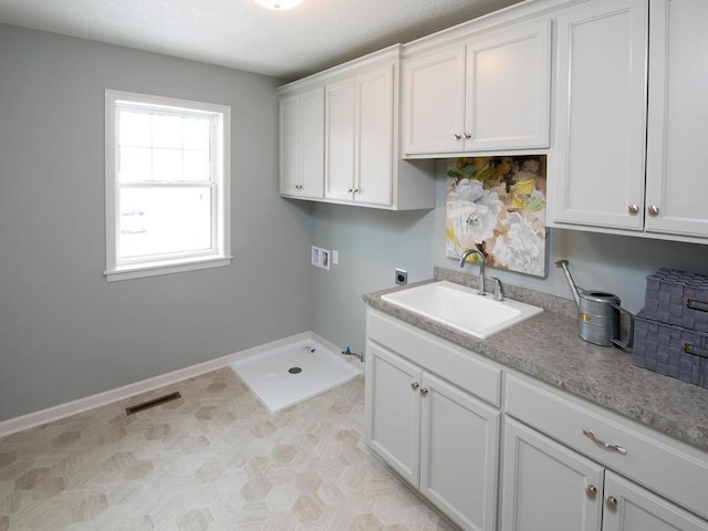 clothes washing area featuring hookup for an electric dryer, hookup for a washing machine, a sink, visible vents, and hookup for a gas dryer