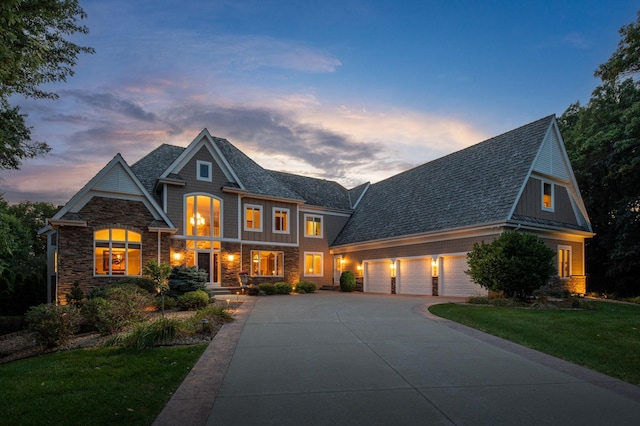 view of front of home featuring a garage and a yard