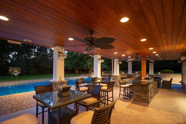 view of patio / terrace featuring ceiling fan and a bar