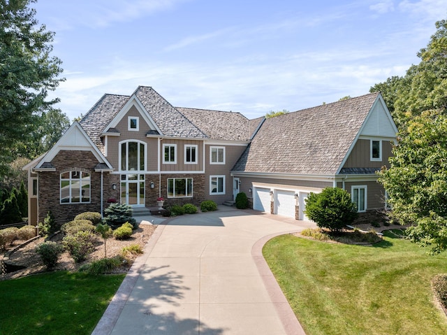 view of front of house with a front yard and a garage