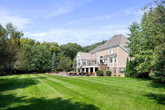 rear view of house featuring a lawn