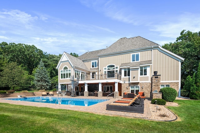 rear view of property with a yard and a patio area