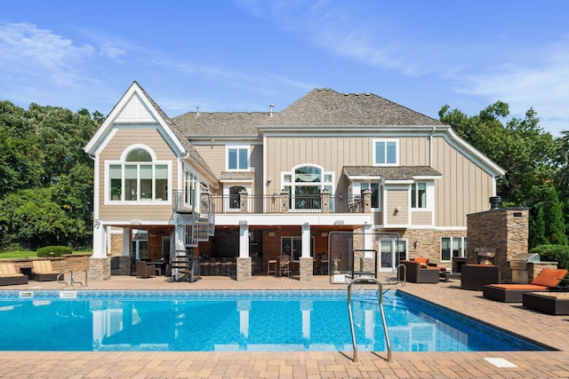 back of house with outdoor lounge area and a patio