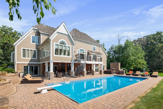 back of house featuring a patio and a balcony