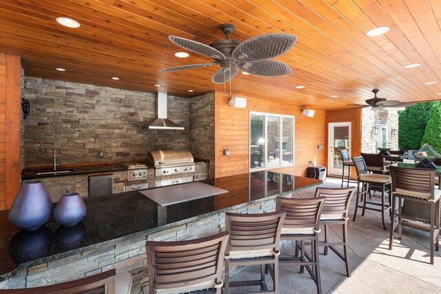 view of patio / terrace featuring ceiling fan, area for grilling, sink, and a grill