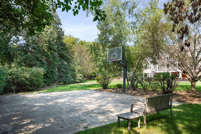 view of sport court with a yard