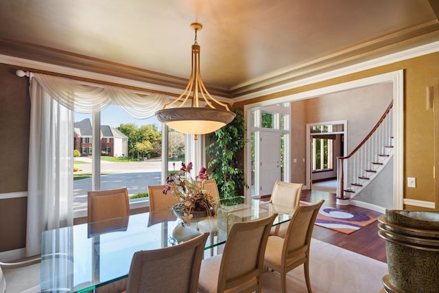 dining room featuring ornamental molding, hardwood / wood-style flooring, and a wealth of natural light