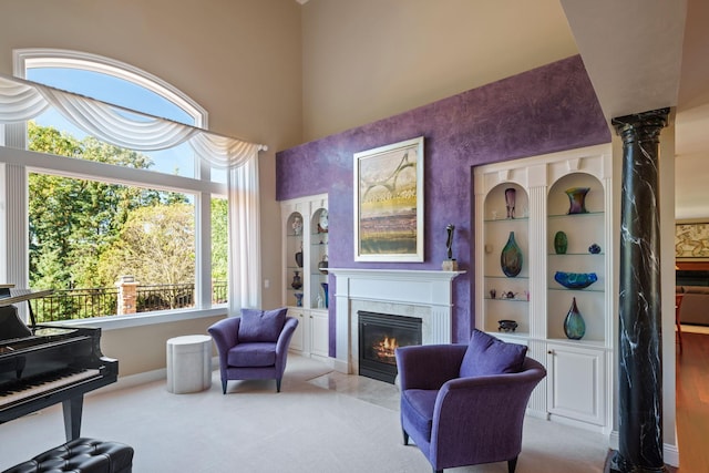 sitting room with light carpet and a fireplace