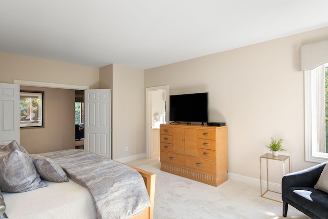 bedroom featuring light carpet and multiple windows