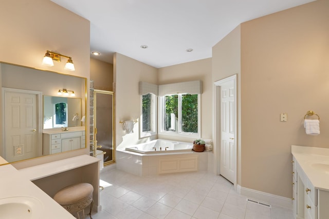 bathroom with tile patterned floors, vanity, and shower with separate bathtub