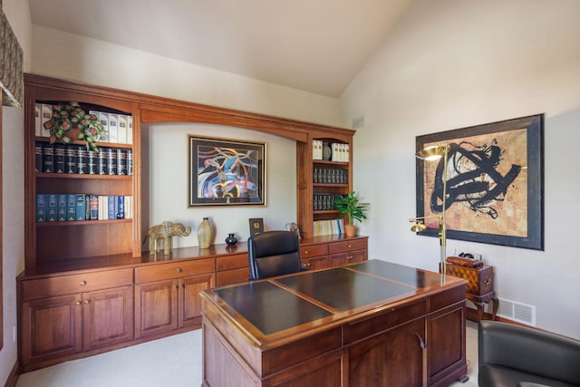 carpeted office featuring vaulted ceiling