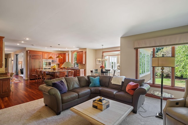 living room featuring an inviting chandelier and dark hardwood / wood-style floors