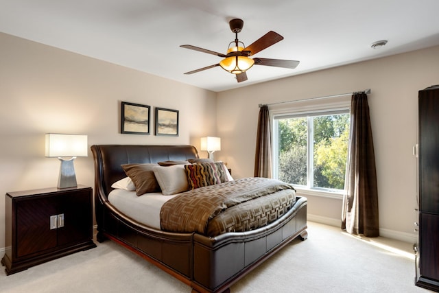 bedroom with ceiling fan and light colored carpet