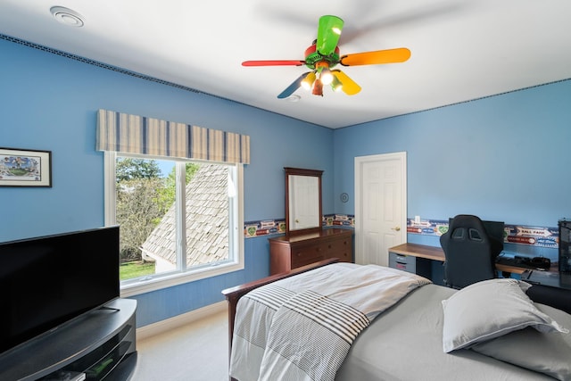 bedroom featuring ceiling fan and carpet