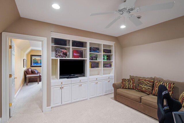 living room featuring light carpet, vaulted ceiling, and ceiling fan