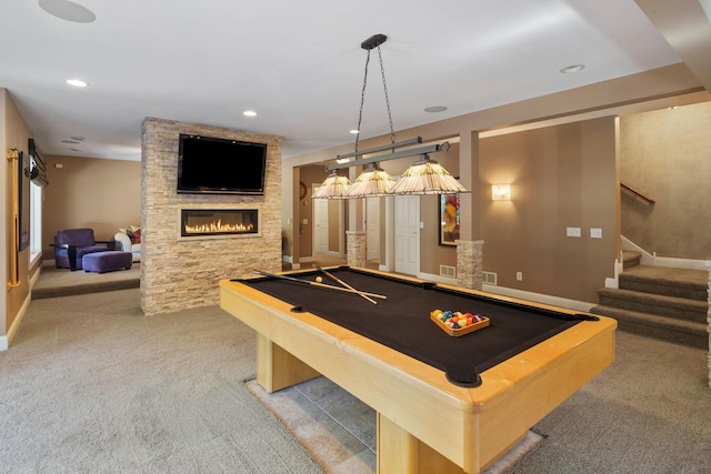 recreation room with pool table, a fireplace, and light colored carpet