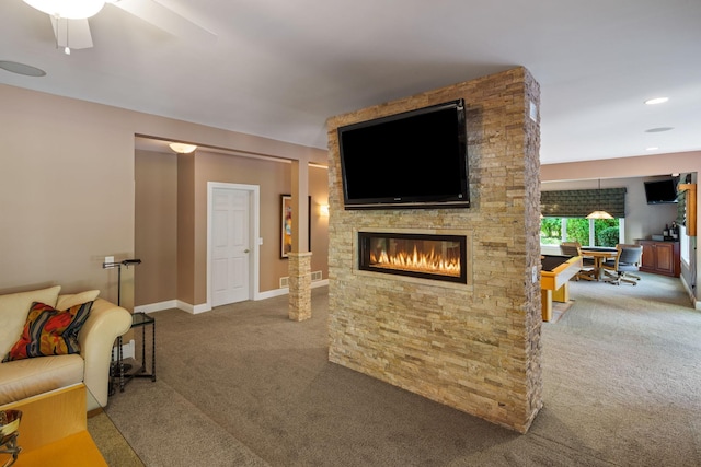 living room with carpet floors, a fireplace, and ceiling fan