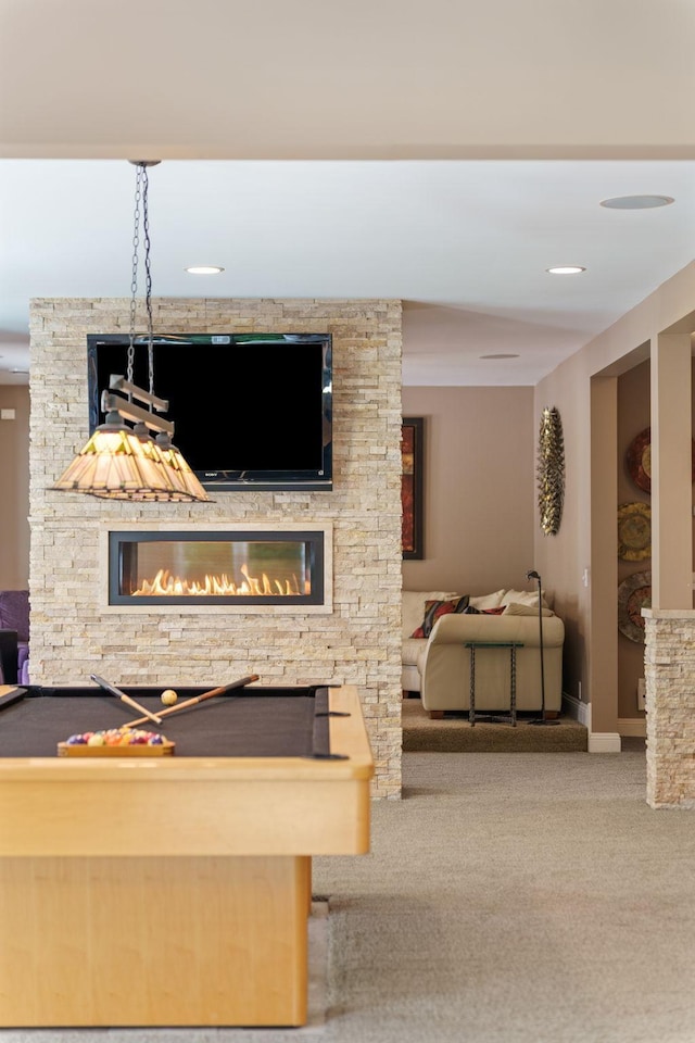 interior space featuring a fireplace, light colored carpet, and pool table