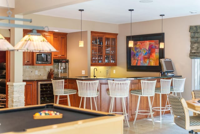 bar with decorative backsplash, beverage cooler, billiards, stainless steel microwave, and pendant lighting