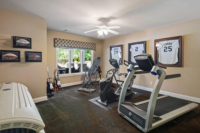 exercise room featuring dark carpet and ceiling fan